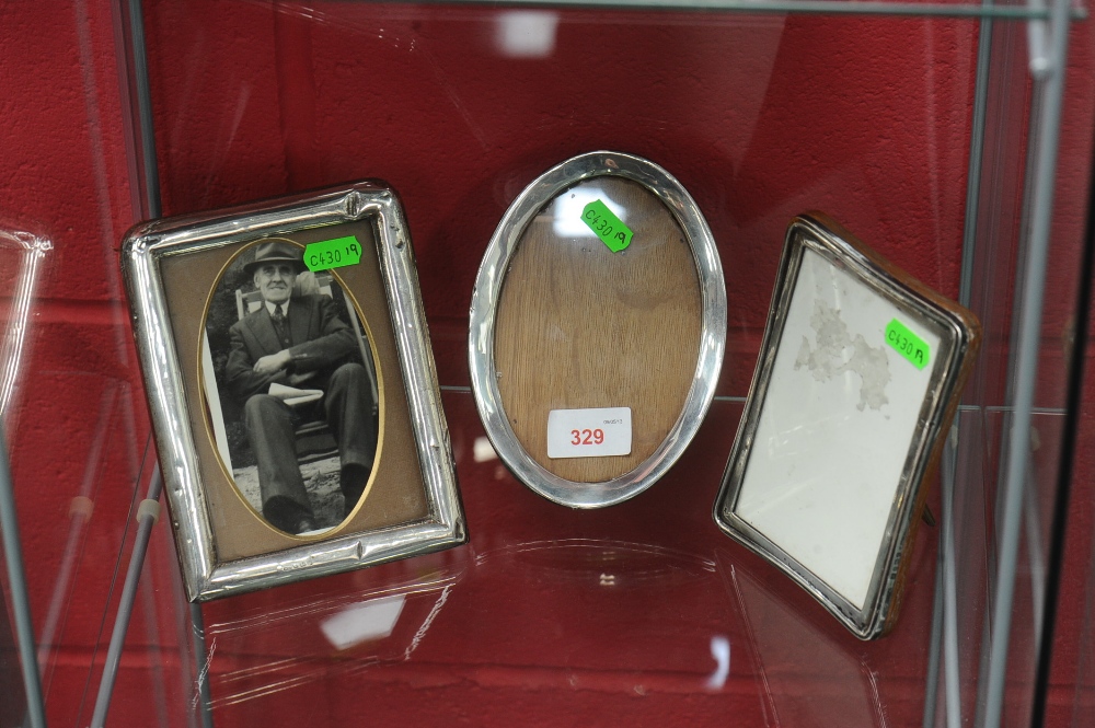 Three 20th century silver easel photograph frames, two rectangular, one bearing the mark for A & J