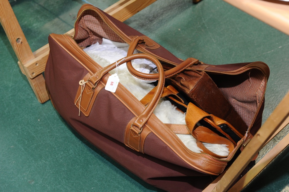 A sportsbag containing a sheepskin rug, petticoat, snakeskin handbag etc.