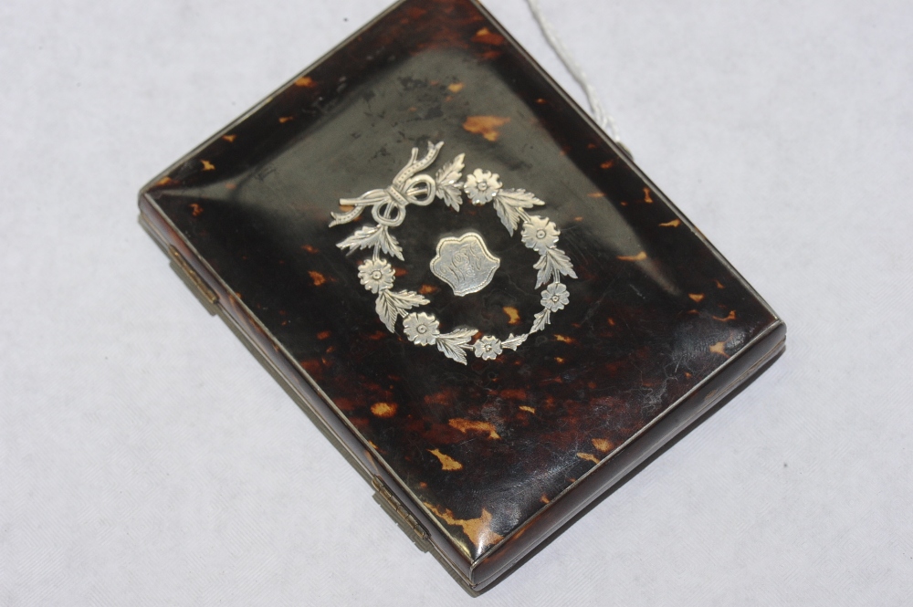 An Edwardian tortoiseshell pique work purse, the cover with floral garland.