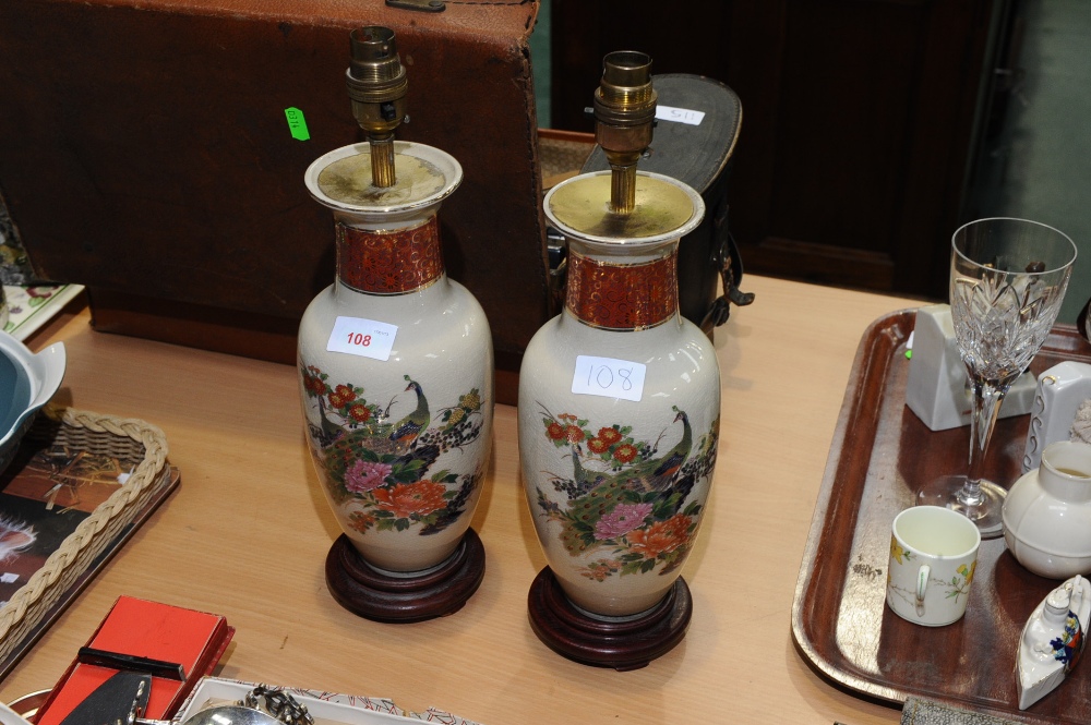 A pair of Japanese vasiform table lamps decorated with peacocks.