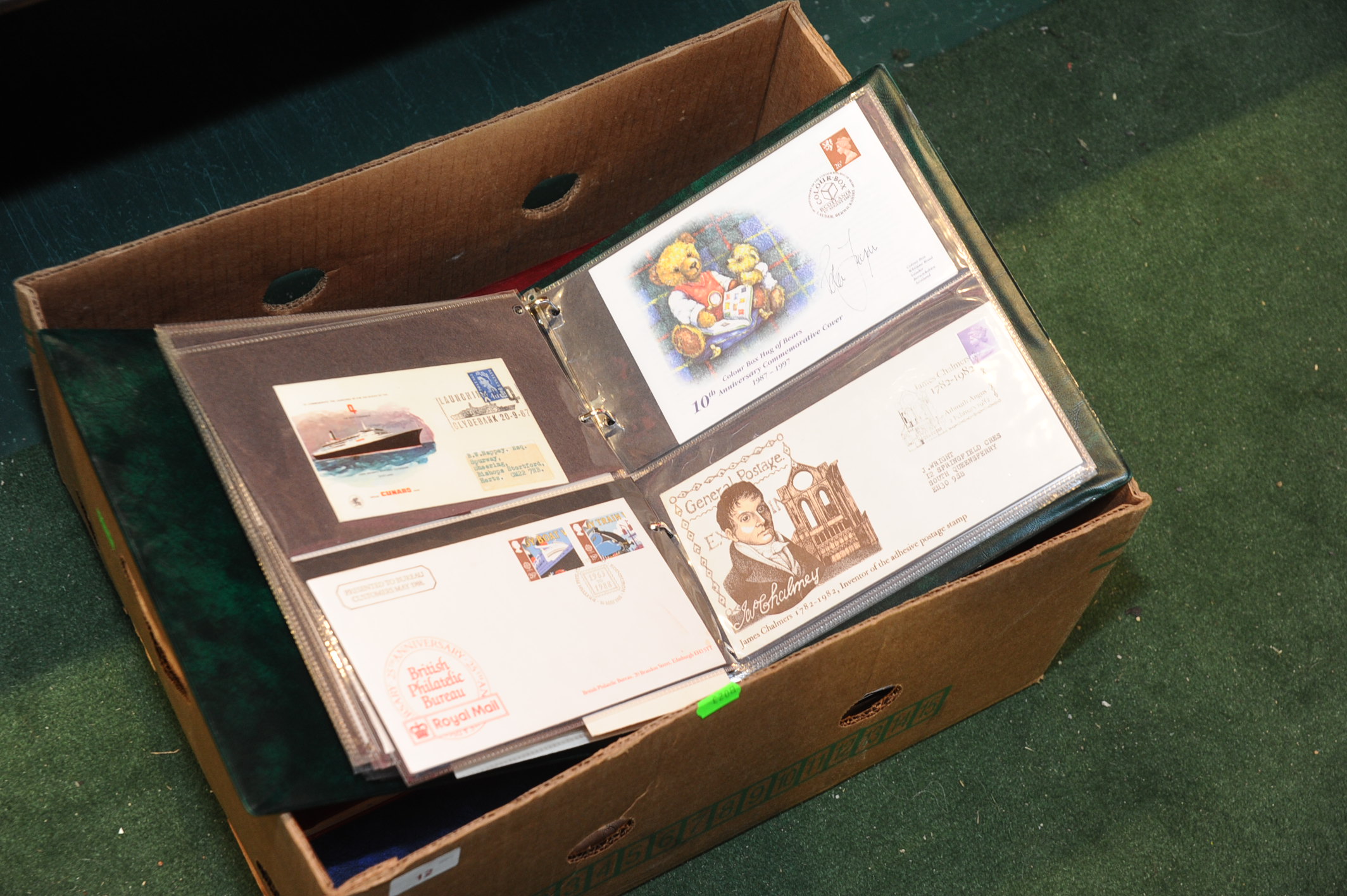 A box containing three GB and World stamp albums and two first day cover albums