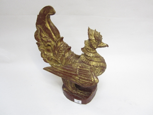 A BURMESE CARVED AND GILT LAMP STAND, modelled as a standing bird, 44cm.