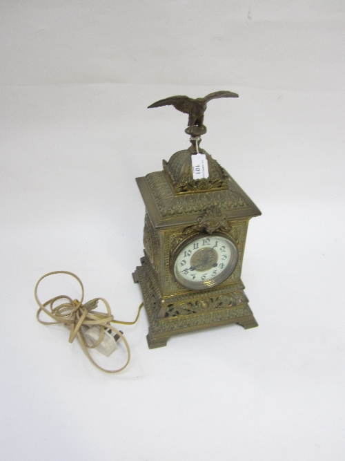 A CAST BRASS MANTEL CLOCK with an eagle surmount, ivorine chapter ring replaced with an electric