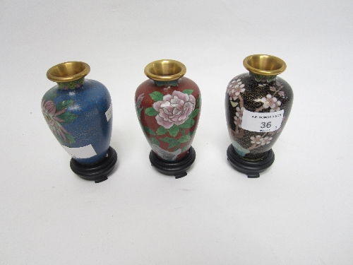 THREE CHINESE CLOISONNE SHOULDERED VASES, floral decoration on respectively a black, blue and red