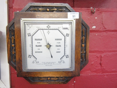 AN OAK CASED WALL BAROMETER, octagonal case, square dial, width 29cm.