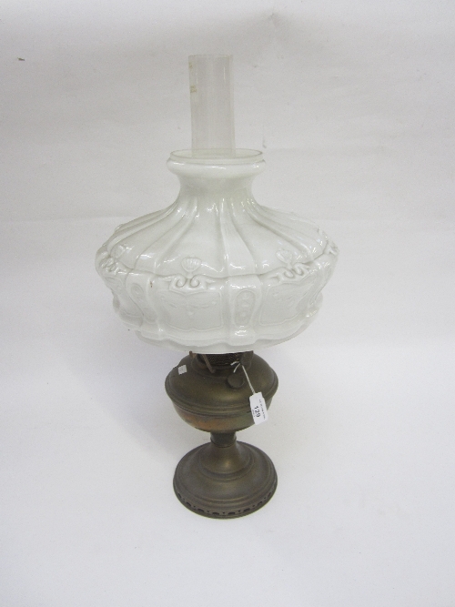 A BRASS OIL LAMP, with moulded opaque shade, complete with chimney, 61cm. overall.