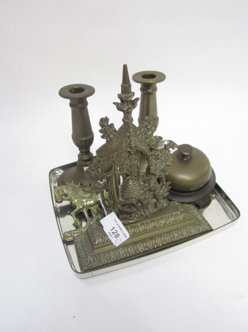 A BRASS TABLE BELL, diameter 11cm., a brass plaque, Ploughing, a pair of candlesticks and a cast