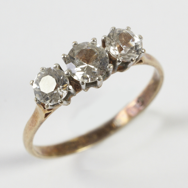 Ladies` three stone ring, comprising white stones, possibly spinels, each stone in crown setting,