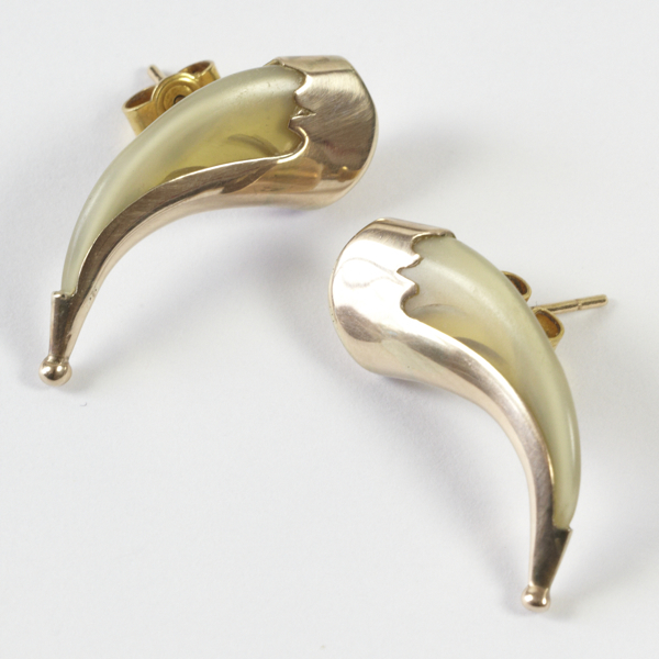 Pair of tiger dew claw stud earrings, approx. 25mm, encased in gold frames, post & butterfly