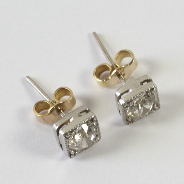 Pair of diamond solitaire earrings, comprising early brilliant cut stones, total weight approx. 0.50