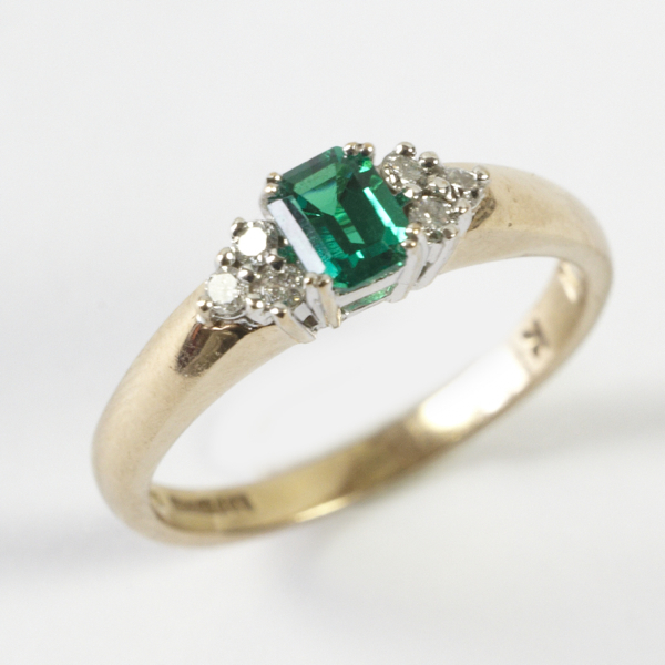 Ladies` tourmaline & diamond set ring, comprising green hexagonal stone in four claw setting to