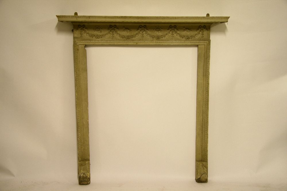 An 18th century style painted pine & gesso fire surround with frieze of floral swags & moulded