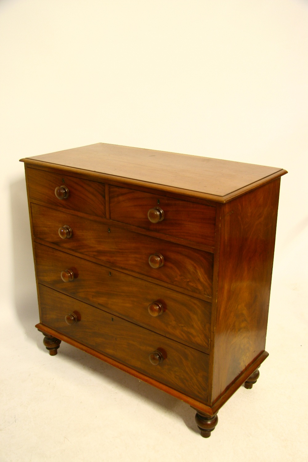 An early Victorian mahogany chest fitted two short & three long graduated drawers with turned knob