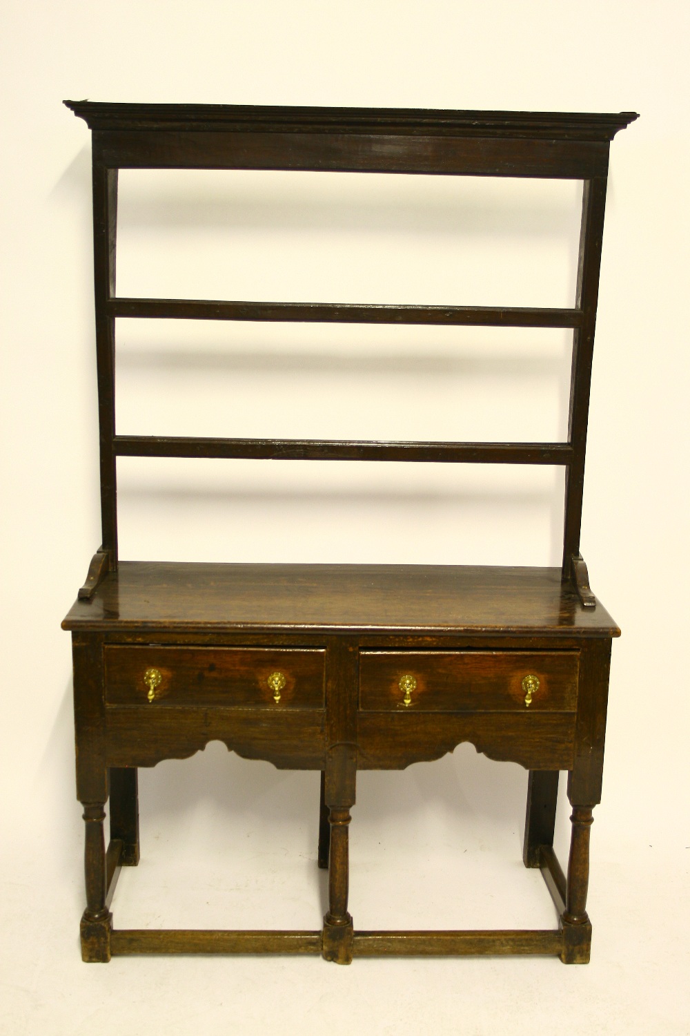 A LATE 18th century OAK SMALL DRESSER with open shelves above, fitted two frieze drawers with