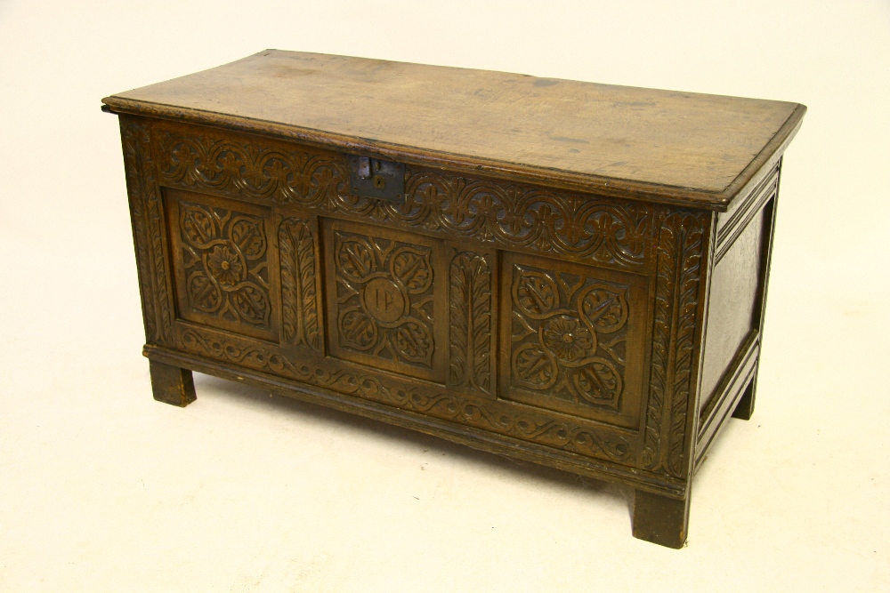 A late 17th century oak coffer with hinged lid, carved triple-panel front; 52½" wide.