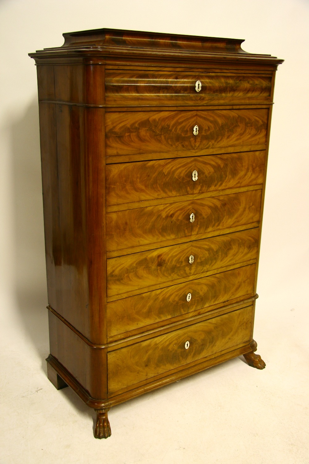 A 19th century Danish figured mahogany tall chest with raised top, fitted seven graduated drawers