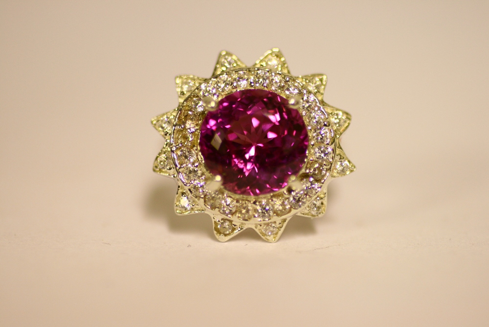 A pink topaz & white sapphire ring, the large round-cut topaz approx. 10mm diam., within a double-