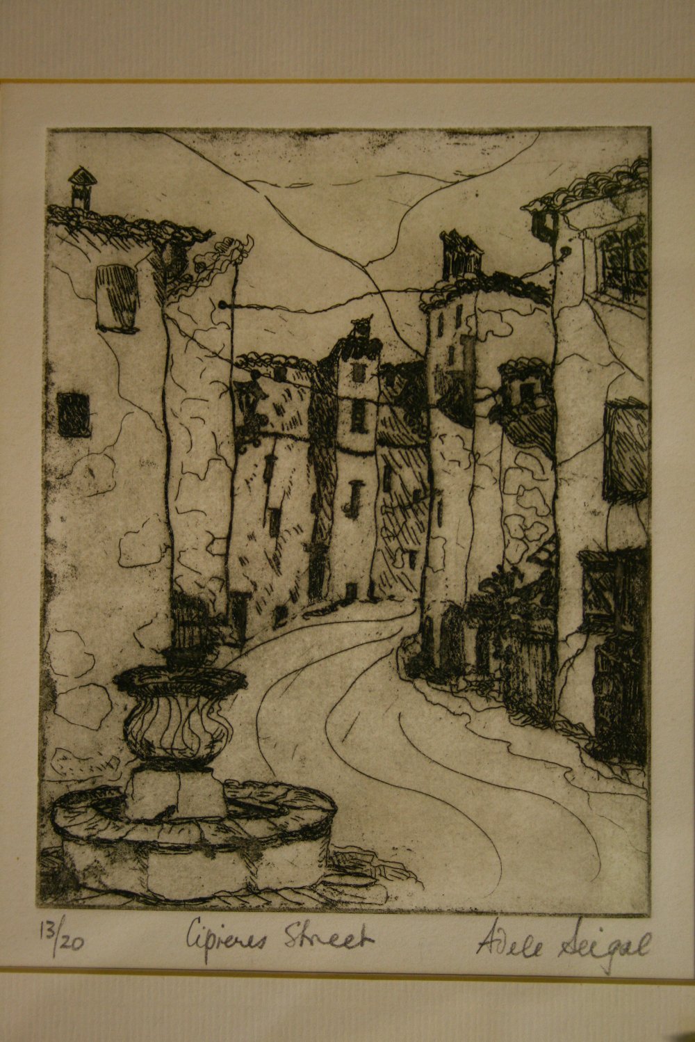 A black & white wood-cut of a continental street scene with fountain to the fore, signed in