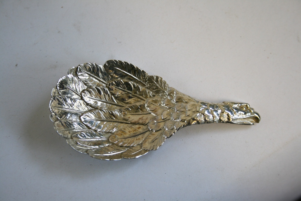 A William IV “EAGLE’S-WING” CADDY SPOON with the eagle’s head forming the handle, 3?" long;