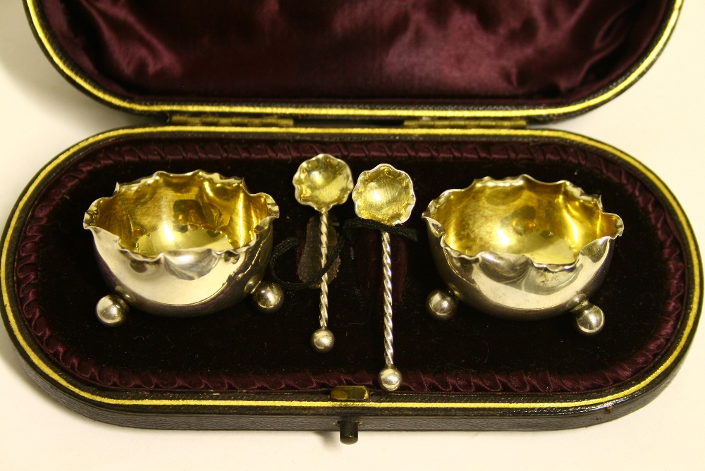 A pair of late Victorian small circular salt cellars with crimped rims, parcel-gilt interiors,