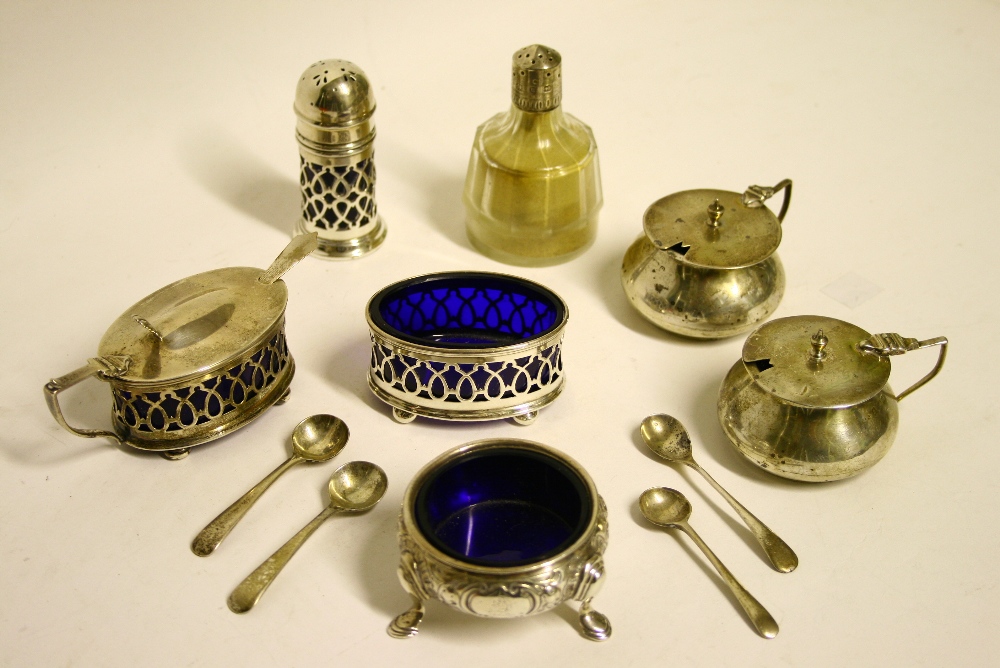 A George V three-piece condiment set with pierced sides & blue glass liners, Sheffield 1919; a