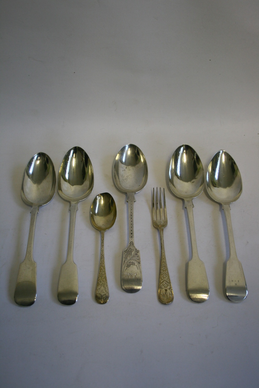 Five Georgian, Victorian, & later Fiddle pattern table spoons – odd dates & makers; a Victorian