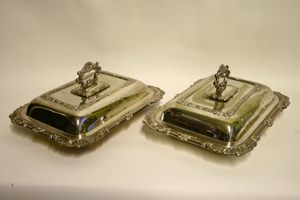 A pair of rectangular entrée dishes with reeded foliate borders, detachable ring handles, & engraved