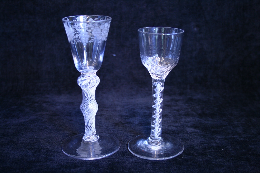 An 18th century drinking glass, the ogee bowl with moulded spiral flutes to the lower part, the