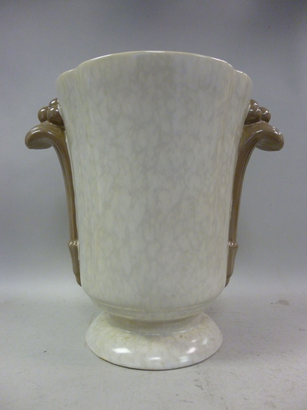 A 1930s Poole pottery Art Deco sponged and solid two tone brown glazed vase with opposing, moulded