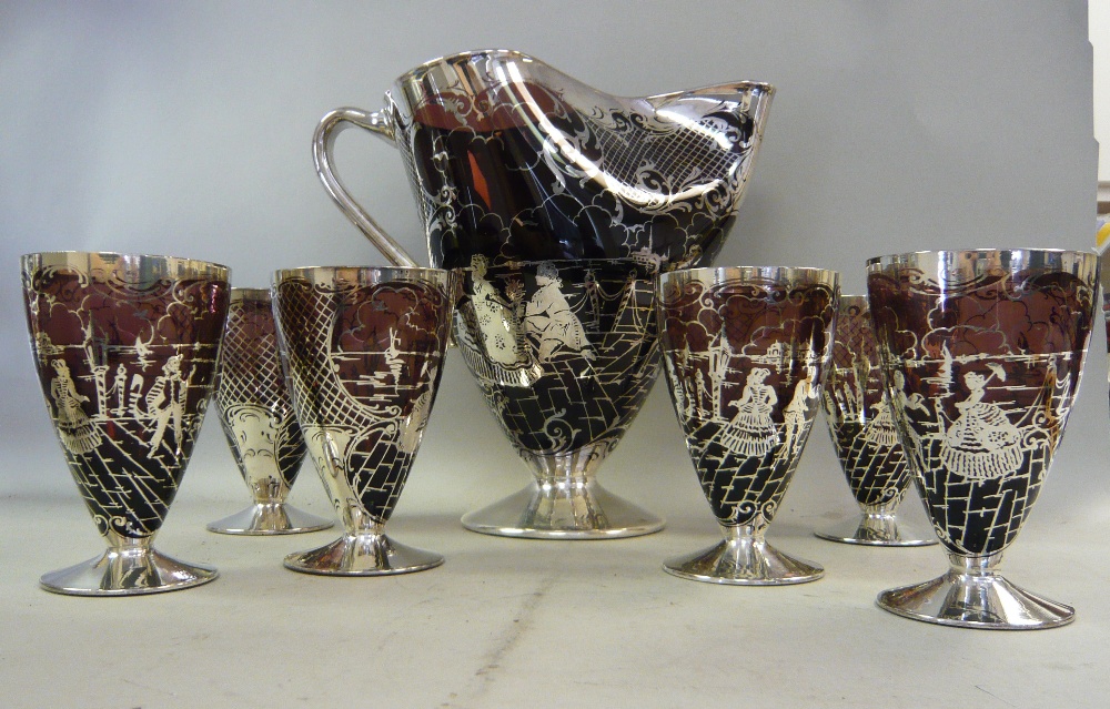 A 1950s Murano semi-opaque, claret coloured glass cordial set, decorated in applied silver with