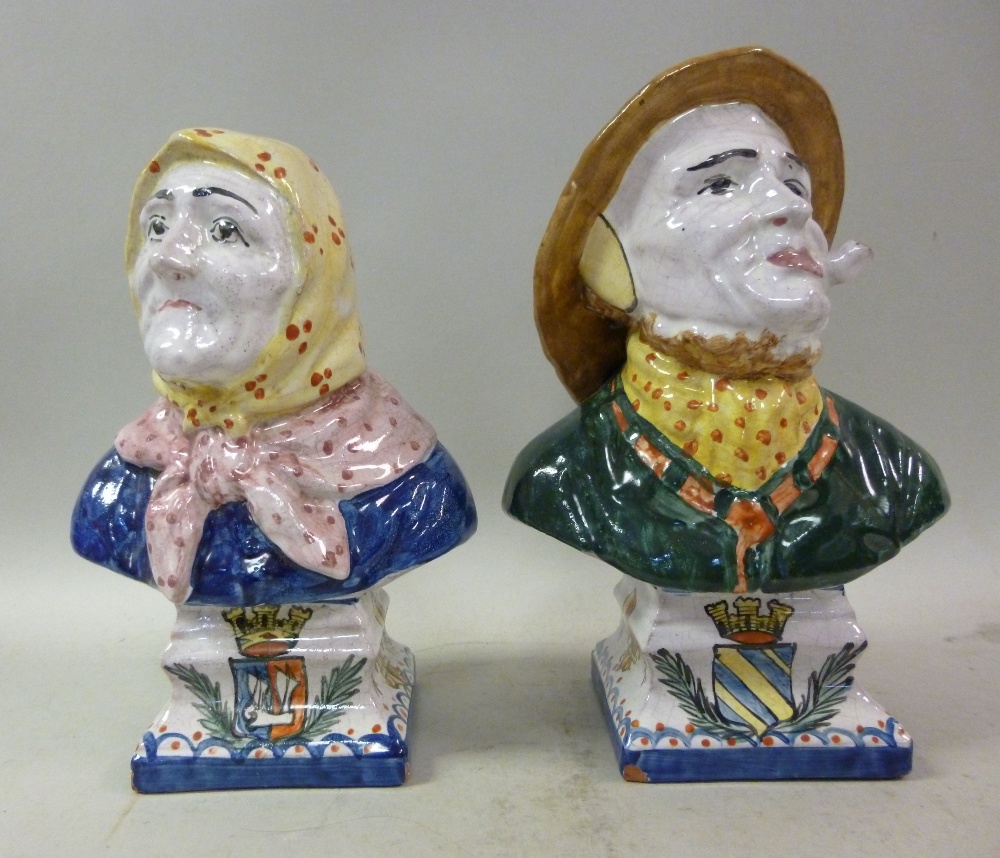 A pair of mid 19thC Rouen faience pottery busts, an elderly couple, she wearing a headscarf, he