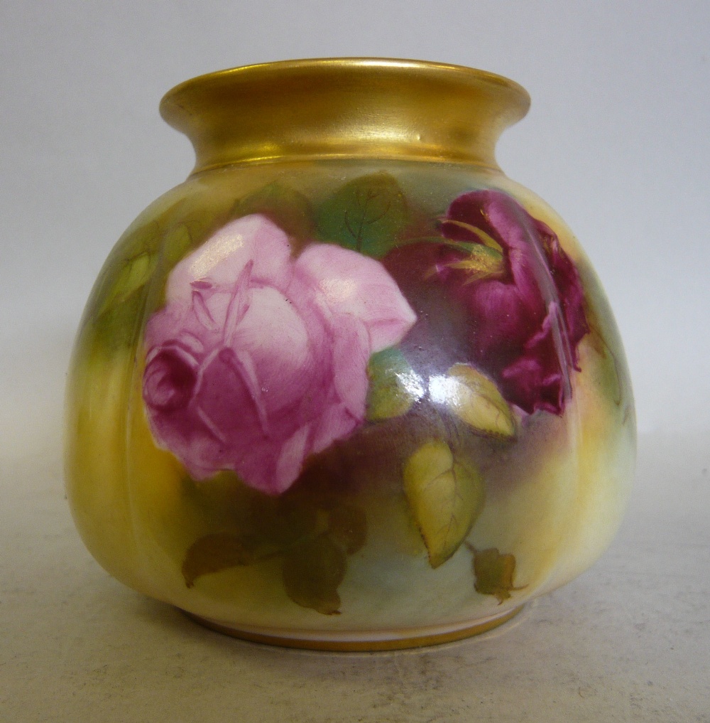 A Royal Worcester blush ivory glazed china bag pot, decorated with rose sprigs and gilding bears a