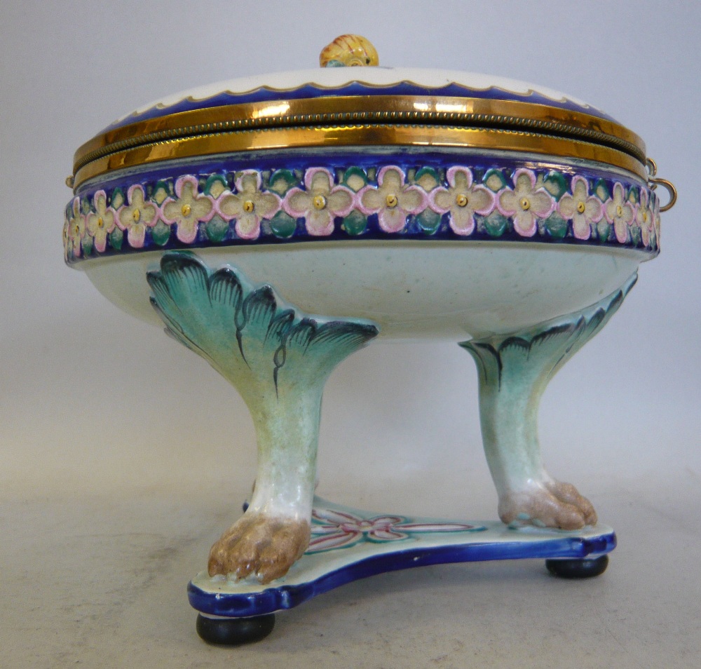 An early 20thC Continental porcelain circular box of shallow design, having an applied brass