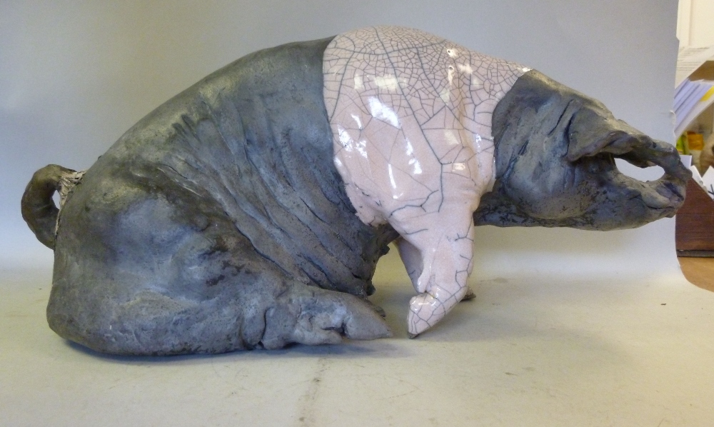 Attributed to Lawson Rudge, raku pottery model, a seated Saddle-Back sow, decorated in black and