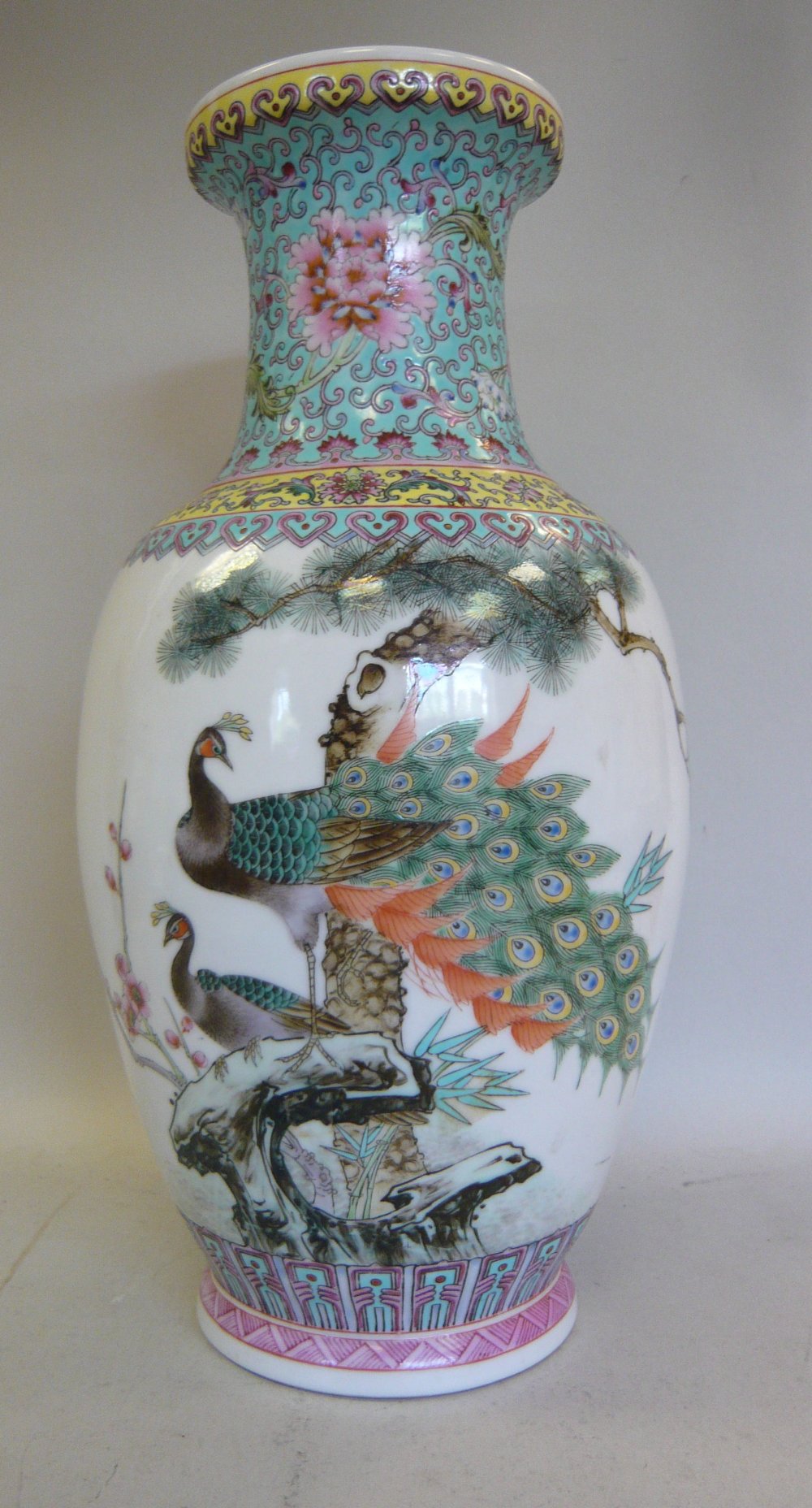 A mid 20thC Chinese porcelain vase of baluster form, having a waisted neck and an upstand rim,