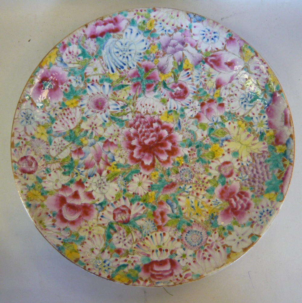 A mid 20thC Chinese porcelain dish, decorated in famille rose in Millefiori pattern bears a Qianlong