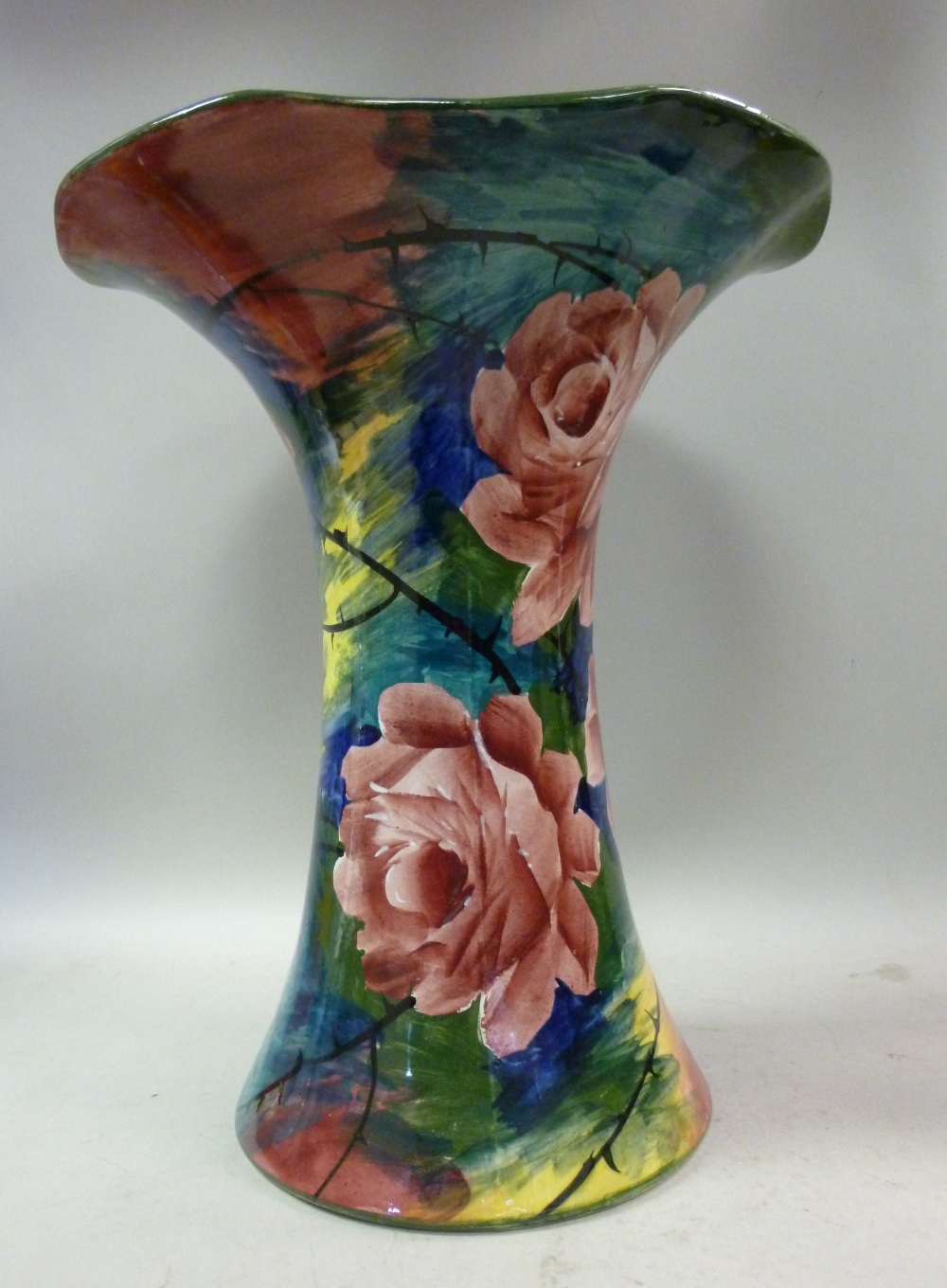 A Wemyss pottery vase of waisted cylindrical form, having a flared, wavy rim, decorated with cabbage