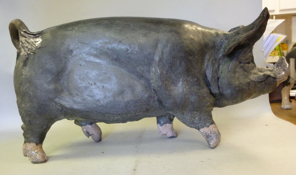 Attributed to Lawson Rudge, raku pottery, a standing Berkshire Boar, decorated in black and pink