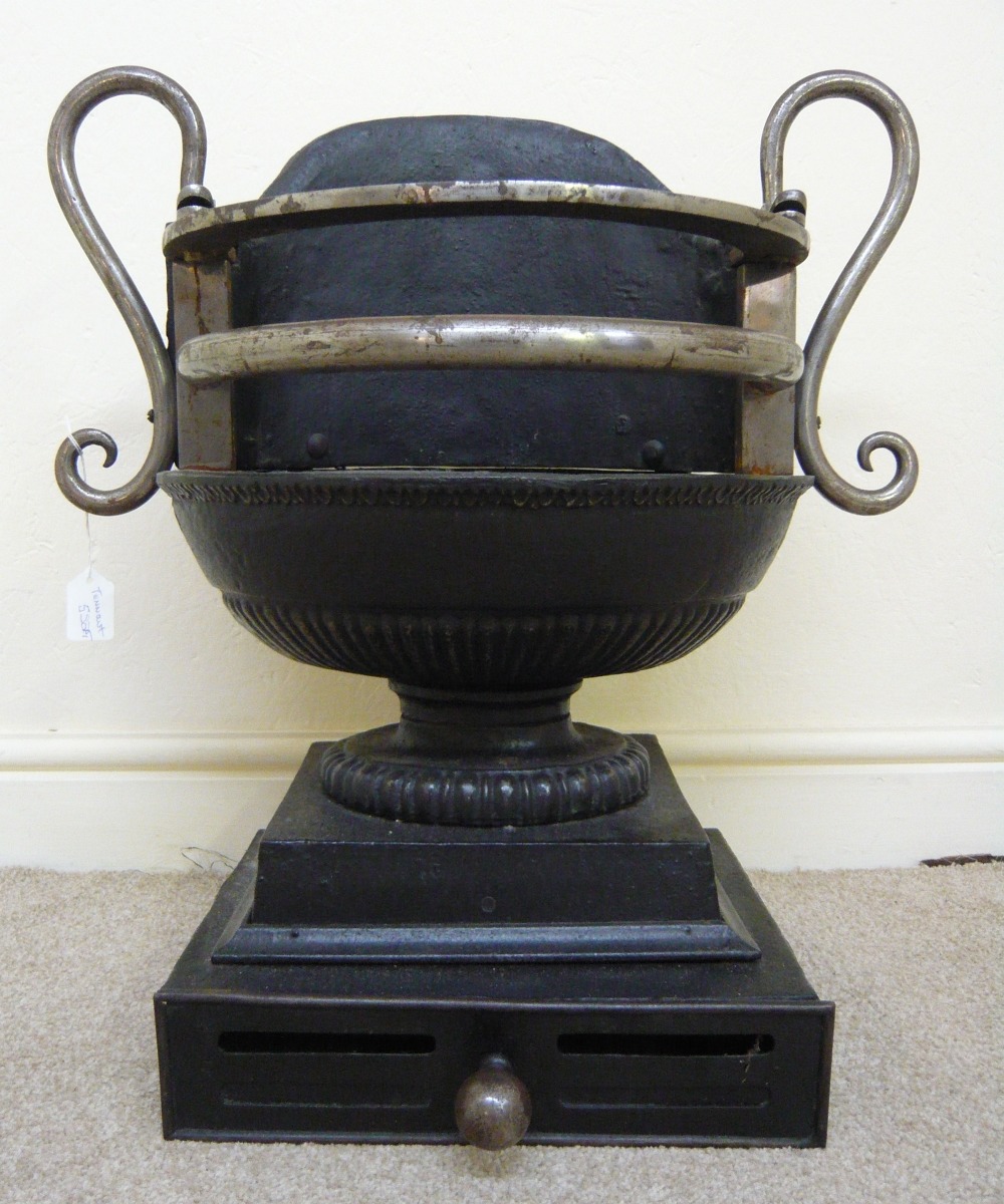 A Georgian black painted and polished steel freestanding fire basket of oval, pedestal form, on a