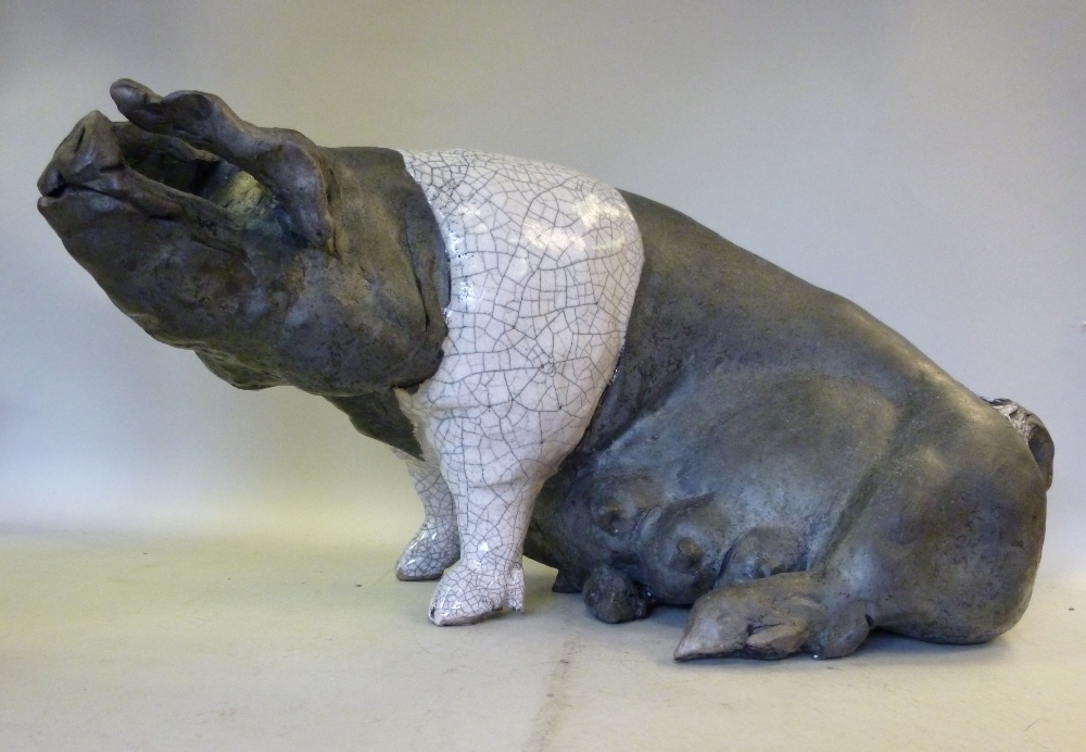 Attributed to Lawson Rudge, raku pottery model, a seated Saddle-Back sow, decorated in black and