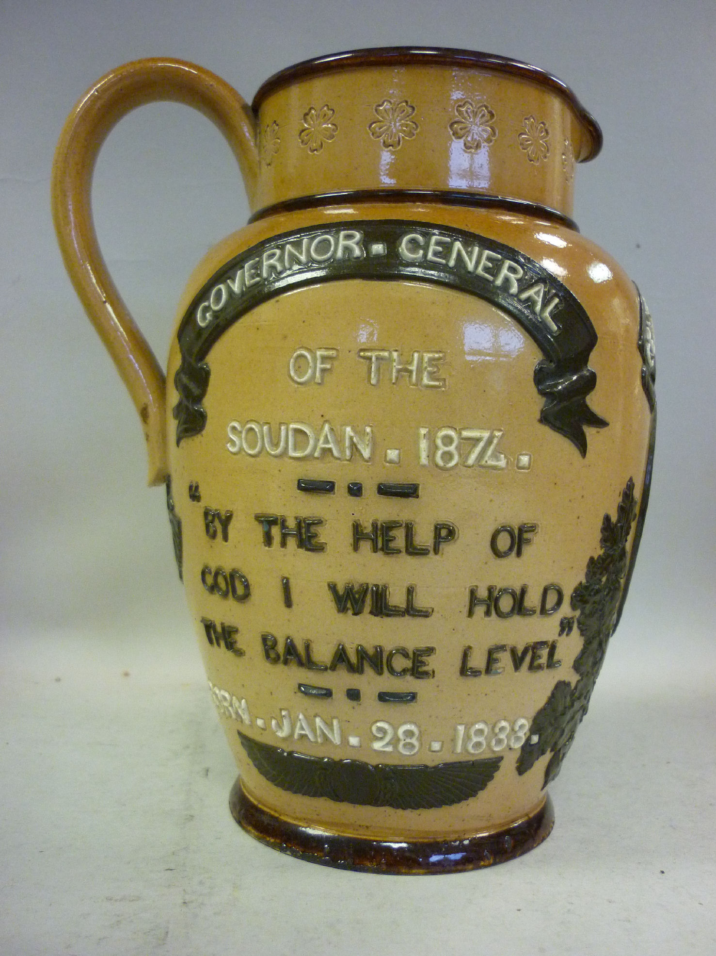 A Doulton Lambeth two tone brown glazed stoneware jug of baluster form, having an upstand rim,