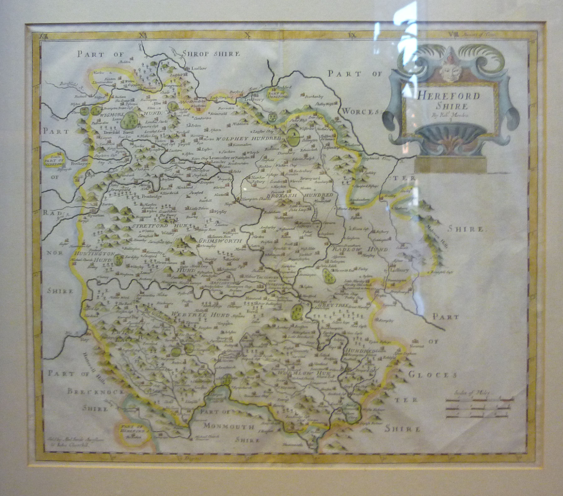 An early 18thC Robert Morden coloured county map `Herefordshire` with a scrolled and mask title