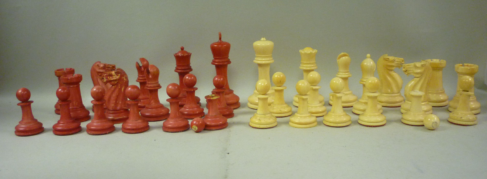 A late 19th/early 20thC naturally coloured and beetlenut stained, carved and turned ivory chess