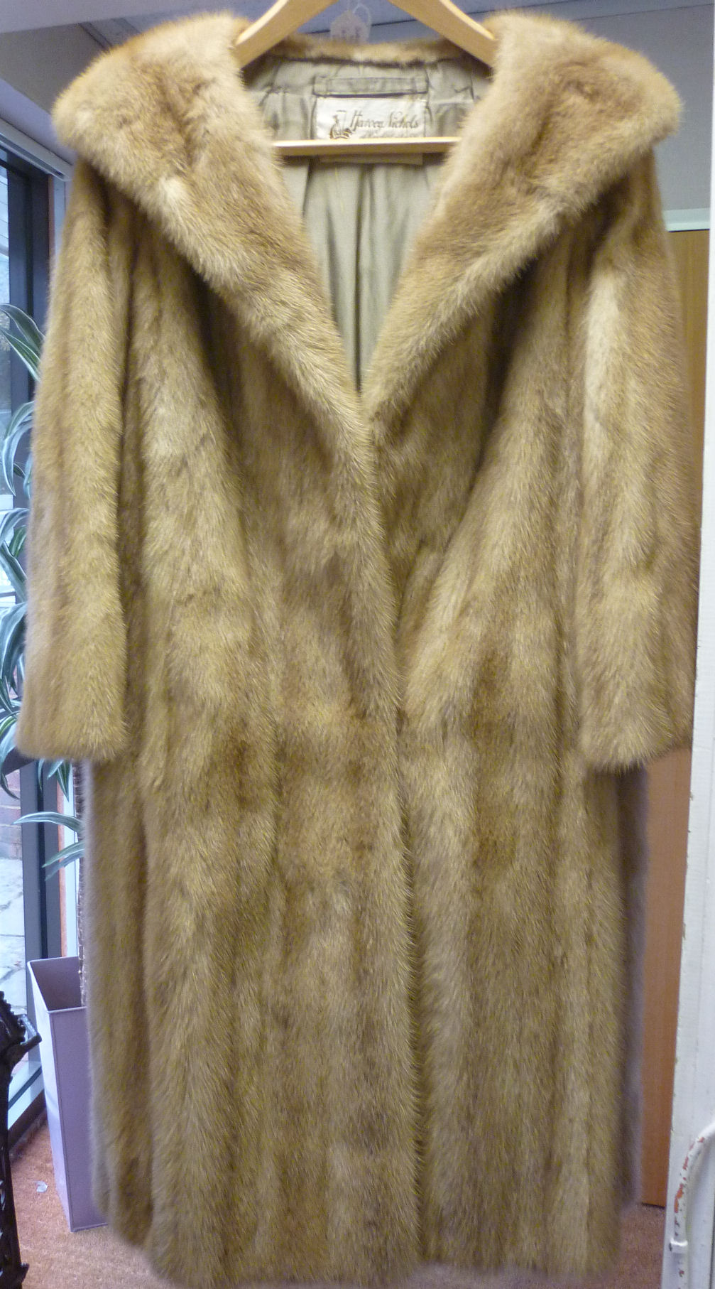 A full length, satin lined mink coat bears a Harvey Nichols label