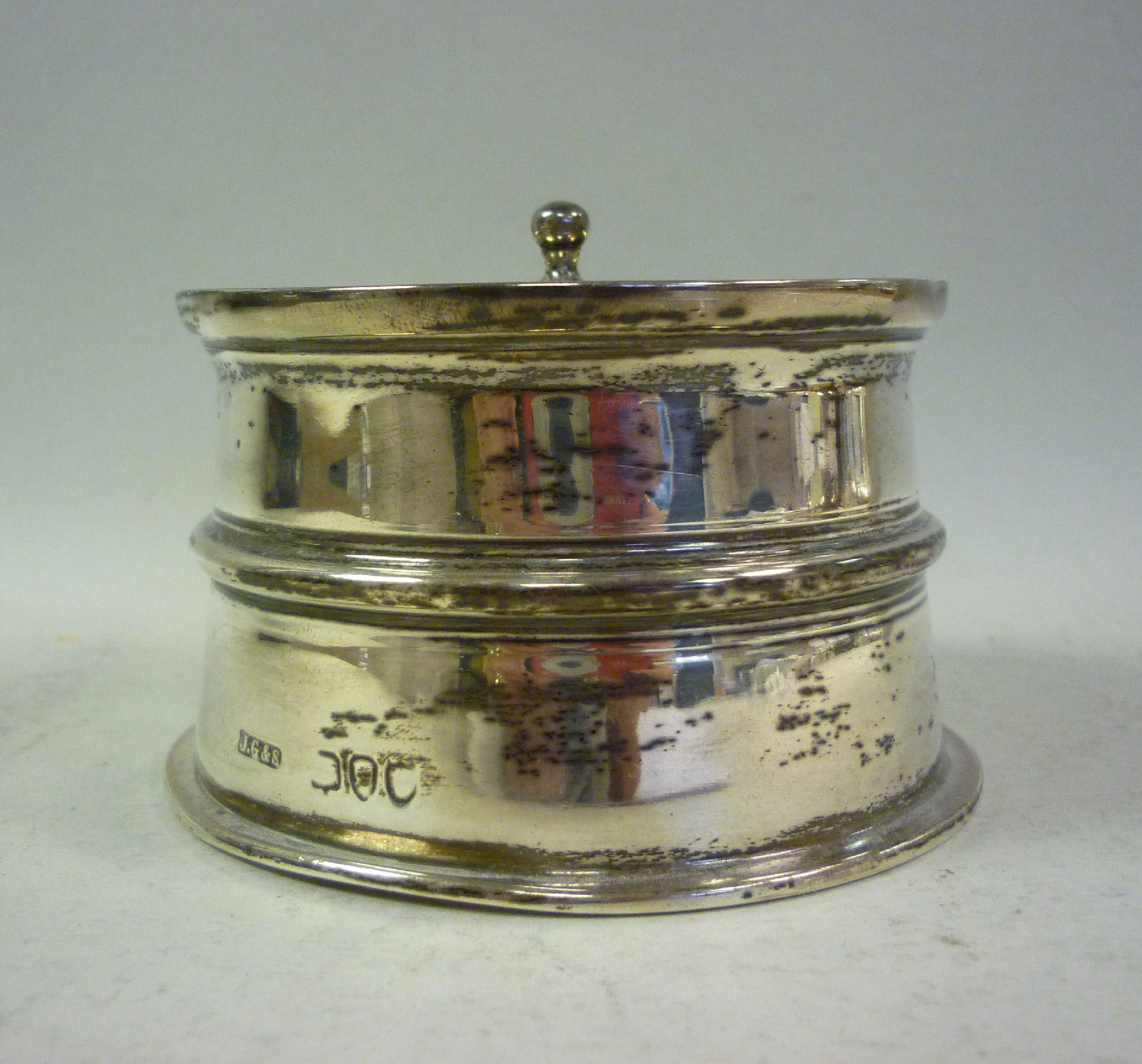 An early 20thC silver inkwell of tapered, drum design with five pen holder apertures, around the