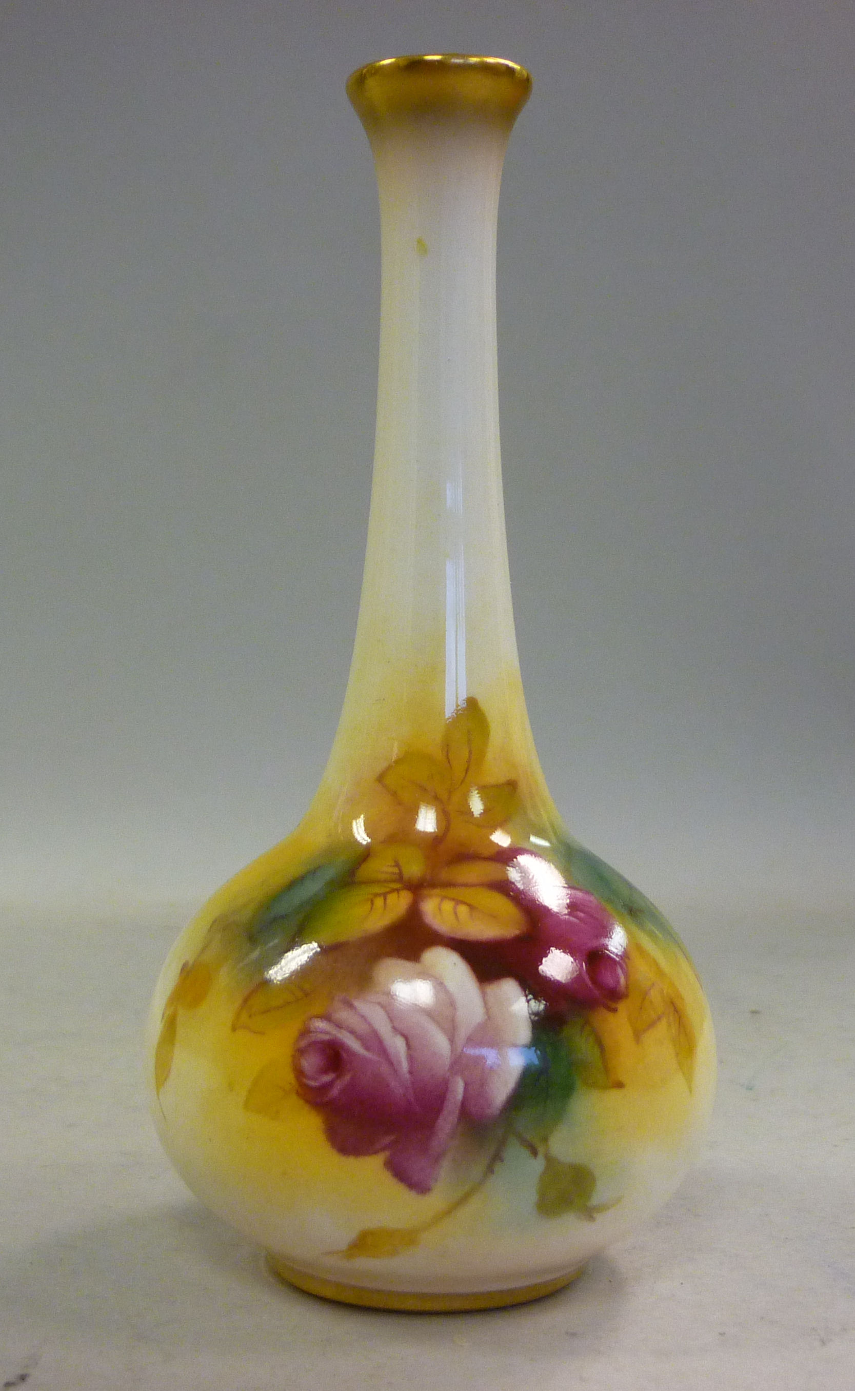 A Royal Worcester ivory glazed china bottle vase, having a long, narrow neck, decorated with roses