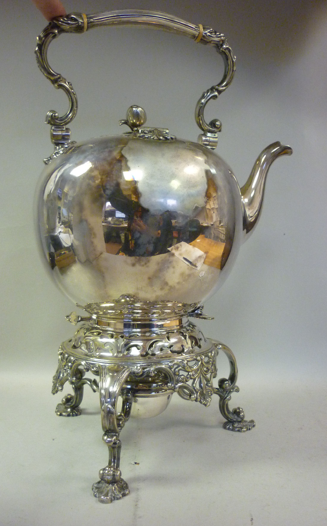 A late Victorian silver plated tea kettle of ovoid form, cast with shell and foliate scrolled