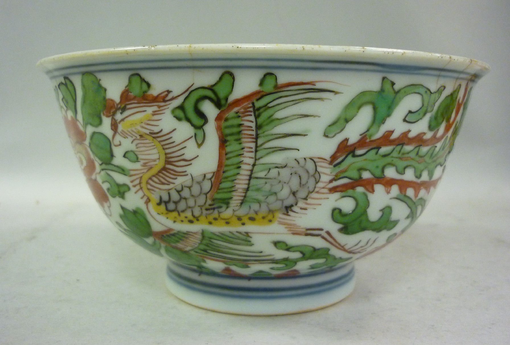 A late 18thC Chinese Kangxi porcelain footed bowl, decorated in Wucai palette with a Phoenix among