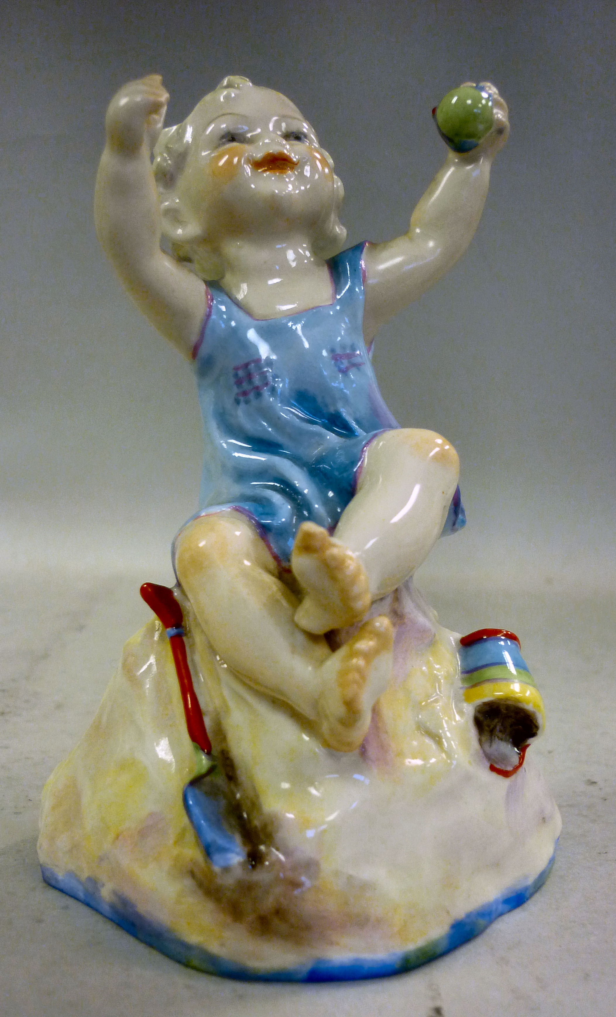 A Royal Worcester china figure, a little girl seated on sand with toys, inscribed `But the child