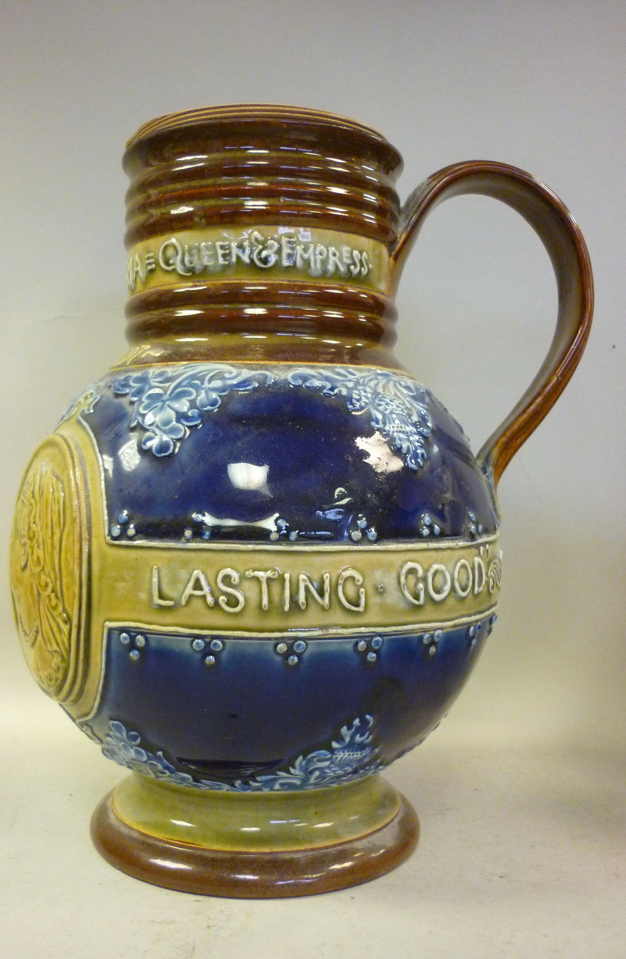 A Doulton Lambeth blue, green and brown glazed stoneware jug of baluster form, having a wide,